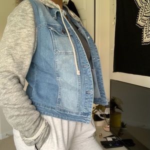 a jean jacket with sweatshirt sleeves